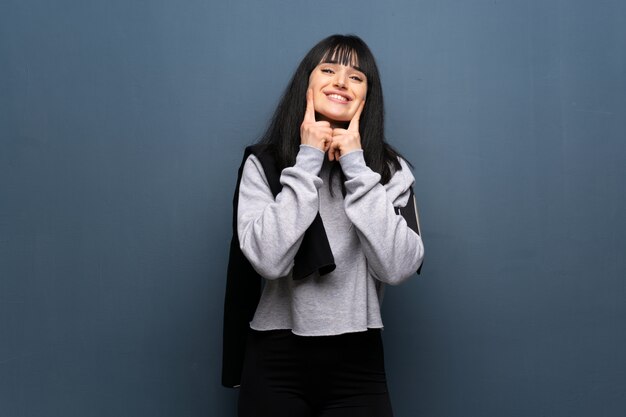 Jeune femme sportive souriante avec une expression heureuse et agréable