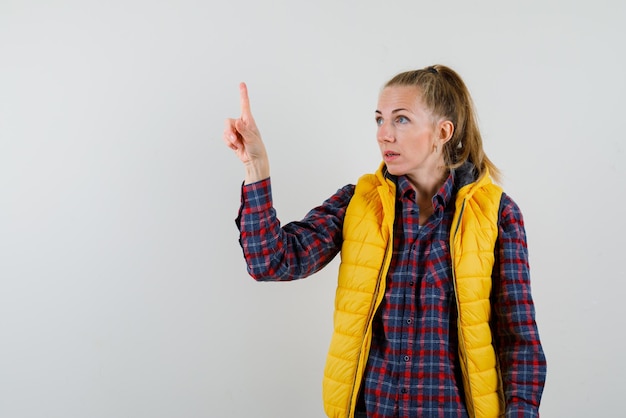 Photo jeune femme touchant sur l'écran avec son doigt sur fond blanc