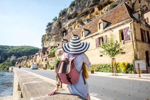 Jeune femme touriste bénéficiant d'une vue magnifique sur les vieux bâtiments du village de La Roque Gageac en France