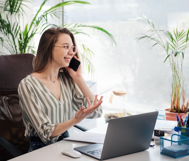 Jeune femme travaillant sur un ordinateur dans son bureau