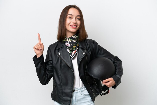 Jeune femme ukrainienne avec un casque de moto isolé sur fond blanc montrant et levant un doigt en signe du meilleur