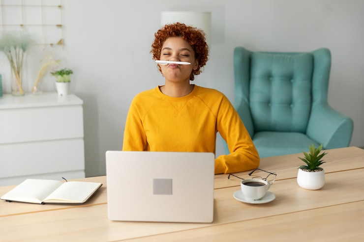 Photo une jeune femme utilise un ordinateur portable alors qu'elle est assise sur le canapé à la maison