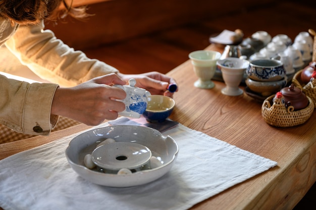 Jeune femme, verser, thé chaud, dans, tasse thé