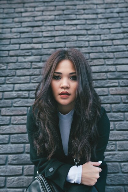 Jeune fille asiatique en manteau sombre