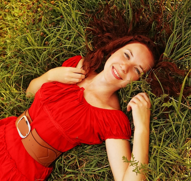 Jeune fille belle pose sur l'herbe