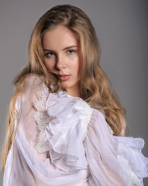 Photo jeune fille en blouse blanche à volants