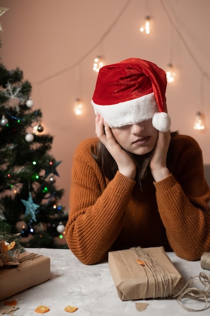 jeune fille brune portant un bonnet de noel sur la tête