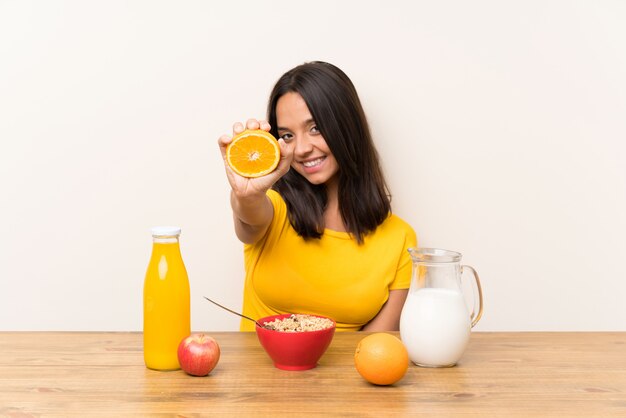 Jeune fille brune prenant son petit déjeuner