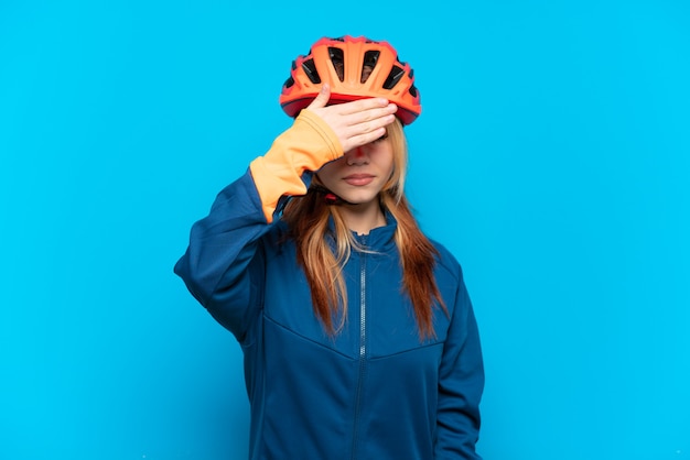 Jeune fille cycliste isolée couvrant les yeux par les mains. Je ne veux pas voir quelque chose