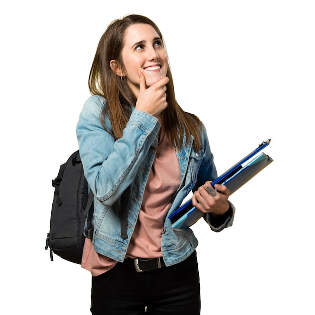 Photo jeune fille étudiante tenant des livres et de la pensée