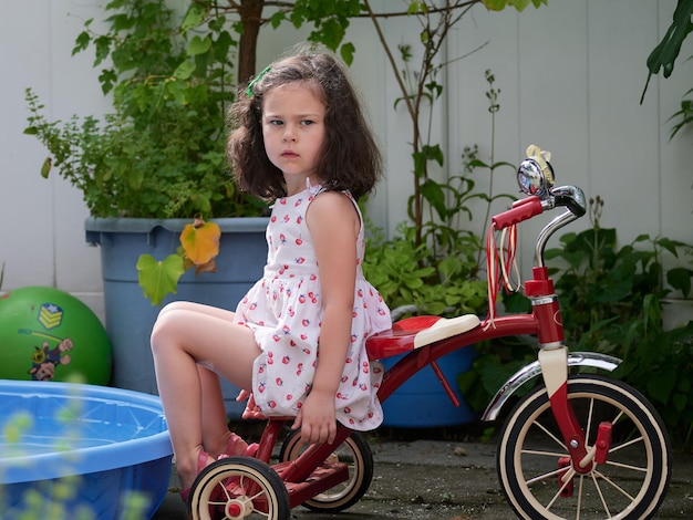 Photo une jeune fille expressive en robe d'été appréciant le jardin.