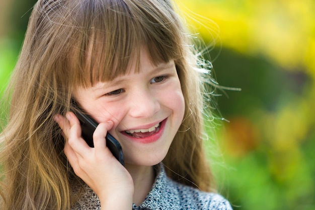 Jeune Fille Mignonne Enfant Parler Au Téléphone Cellulaire à L'extérieur. Les Enfants Et La Technologie Moderne, La Communication.