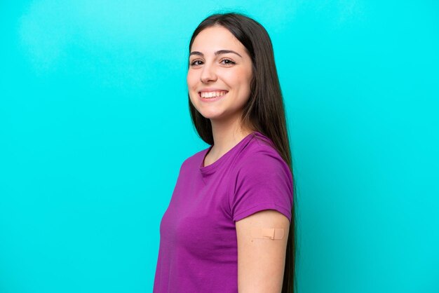 Jeune fille avec des pansements isolés sur fond bleu souriant beaucoup