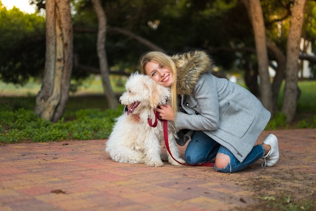 Jeune fille avec son chien dans un parc