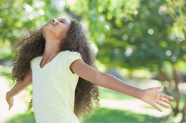 Jeune fille souriante avec les bras tendus