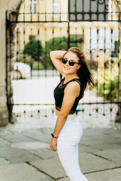 Jeune fille souriante dans la rue aux cheveux longs