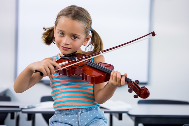 Jeune fille souriante, jouer, violon, dans, classe