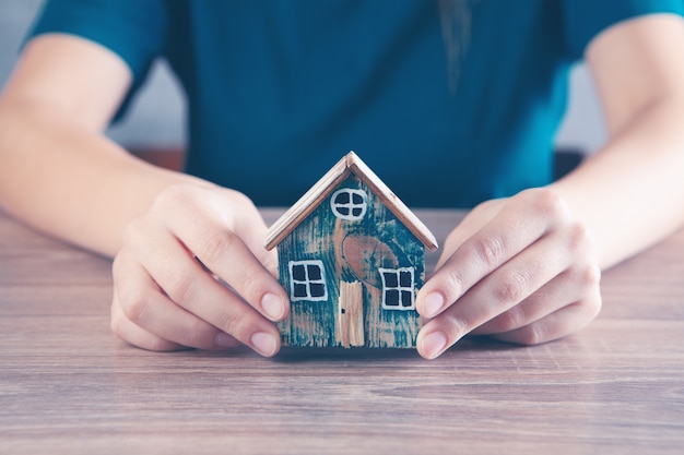 jeune fille tenant une maison