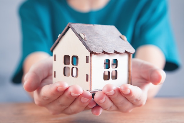 Jeune fille tenant une maison