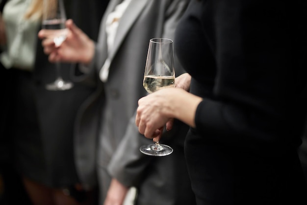 La jeune fille tient un verre à la main. Champagne. Une fête