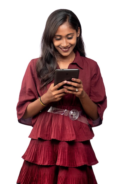 Jeune fille utilisant un téléphone portable ou un smartphone sur fond blanc