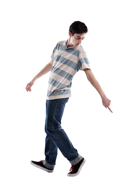 Jeune garçon homme adolescent dansant et sautant isolé sur fond blanc en studio