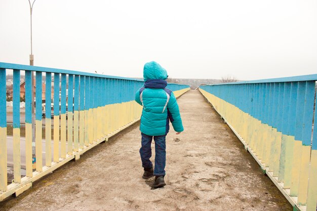 Jeune garçon qui court sur le pont