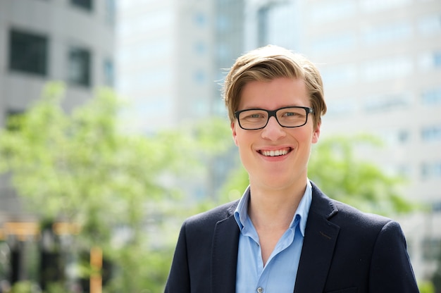 Jeune homme d&#39;affaires, souriant avec des lunettes