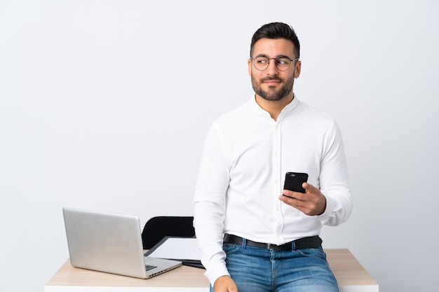 Jeune, homme affaires, tenue, mobile, téléphone, debout, regarder, côté