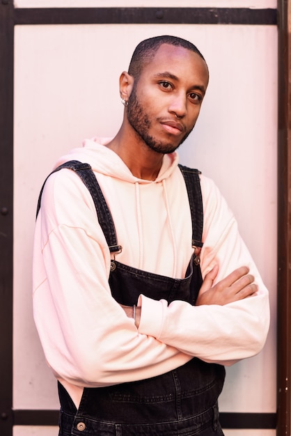 Jeune homme africain avec un pantalon à bavette à l&#39;extérieur