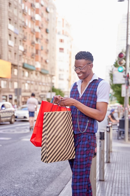 Jeune homme afro-américain regardant à l'intérieur du sac à provisions à l'extérieur