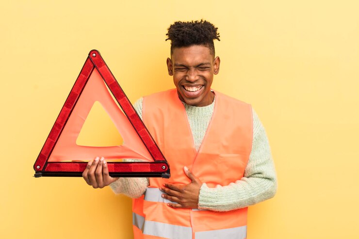 Photo jeune homme afro noir riant à haute voix d'une erreur de voiture hilarante et d'un concept de triangle