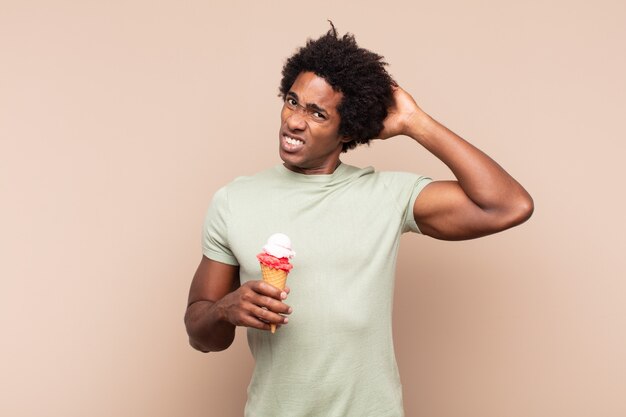 Jeune homme afro noir se sentant stressé, inquiet, anxieux ou effrayé, les mains sur la tête, paniquant à l'erreur