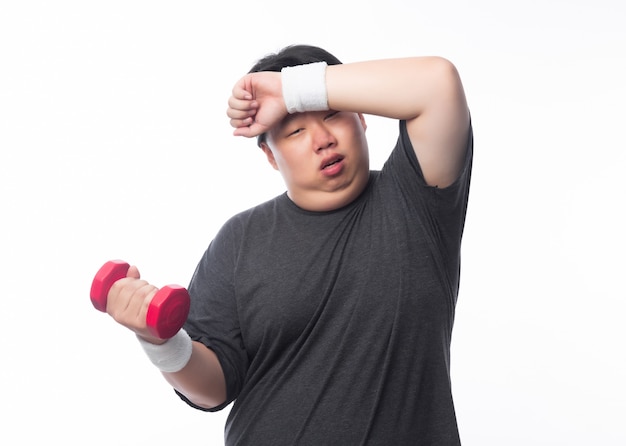 Jeune homme asiatique drôle de sport gras exercice avec haltère isolé