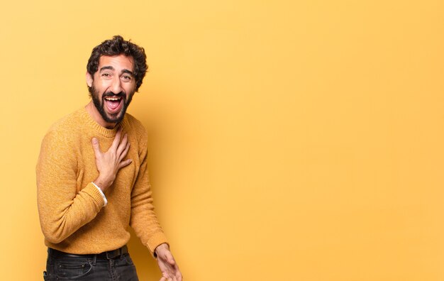 Jeune homme barbu choqué avec pull jaune