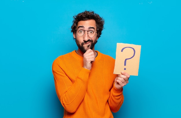 Jeune homme barbu avec un symbole de point d'interrogation