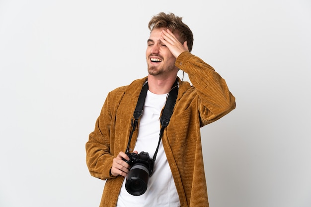 Jeune homme blond photographe isolé sur fond blanc a réalisé quelque chose et a l'intention de la solution