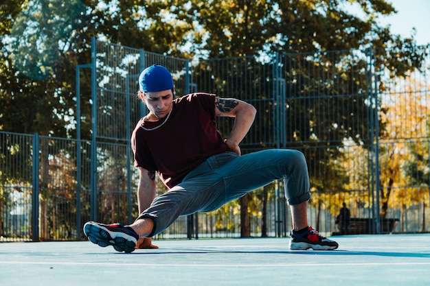 Photo jeune homme break dance au terrain de basket