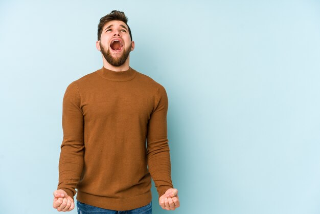 Jeune homme caucasien criant très en colère, concept de rage, frustré.