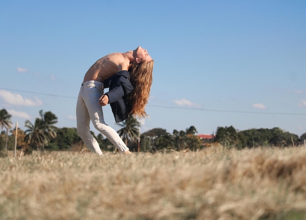 Un jeune homme en chandail blanc aime la nature