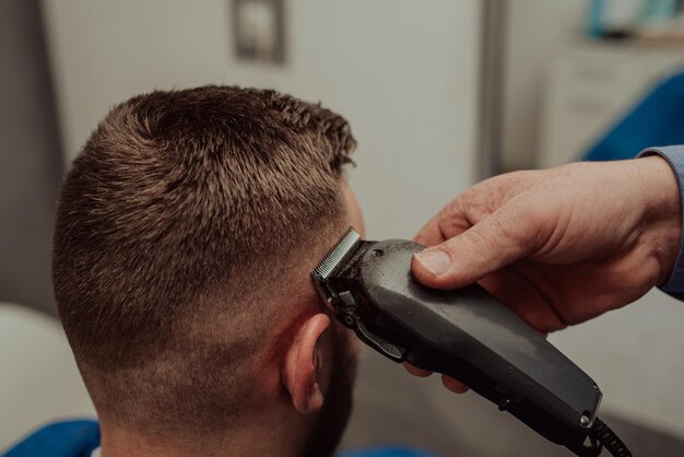 Jeune homme dans le concept de service de soins capillaires du salon de coiffureJeune homme dans le concept de service de soins capillaires du salon de coiffure