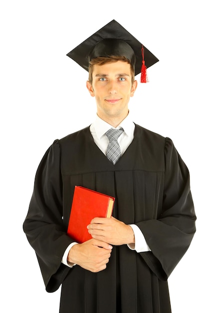 Jeune homme diplômé avec livre isolé sur blanc