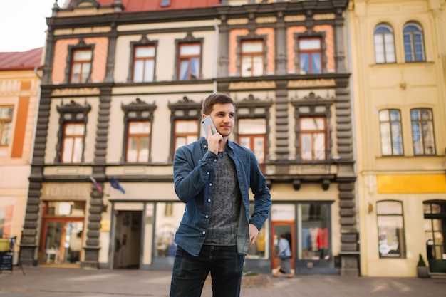 Jeune homme élégant debout au centre de la ville