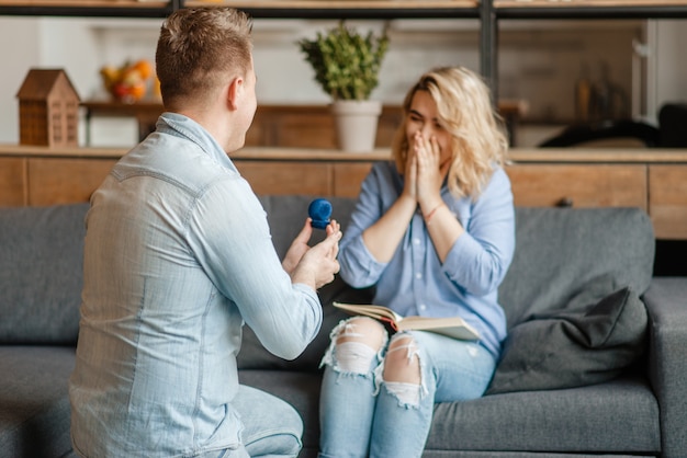 Jeune homme fait une proposition en mariage à sa femme.