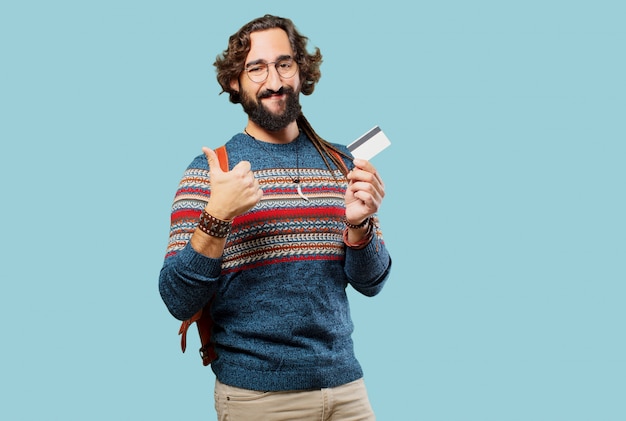 Jeune homme hippie avec une carte de crédit