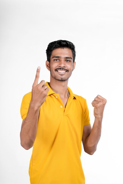 Jeune homme indien montrant l'expression avec la main sur fond blanc