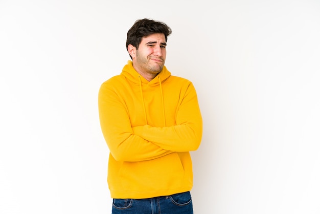 Jeune homme isolé sur blanc mécontent de l'expression sarcastique.