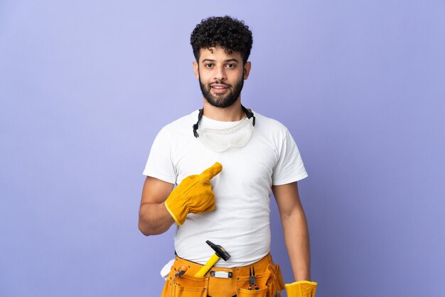 Jeune homme marocain électricien isolé sur mur violet avec expression faciale surprise