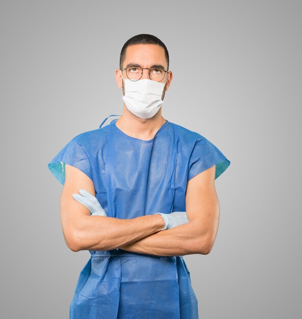 Jeune homme médecin portant un masque et des gants de protection