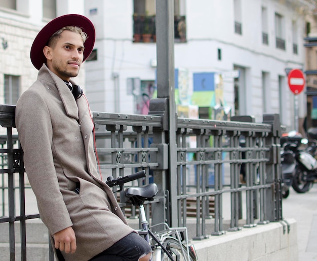 Jeune homme de mode avec chapeau et vélo